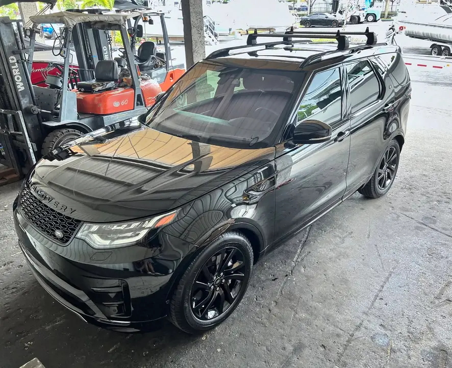 Black Land Rover Discovery after a detail, with marks on its bonnet, panels, glass, nose, wheel and cabin