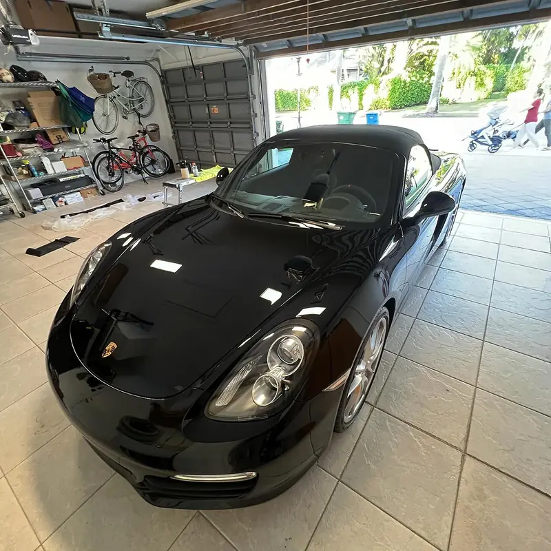 Black Porsche Boxster detailed in its owner's home garage
