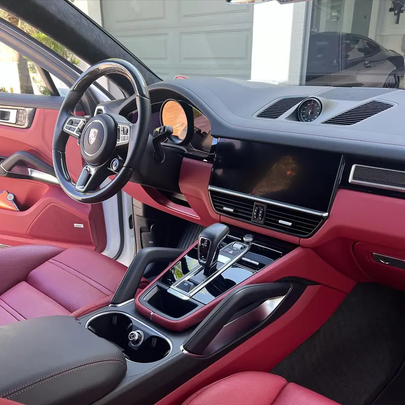 Porsche Cayenne interior with red leather seats and dash, freshly detailed